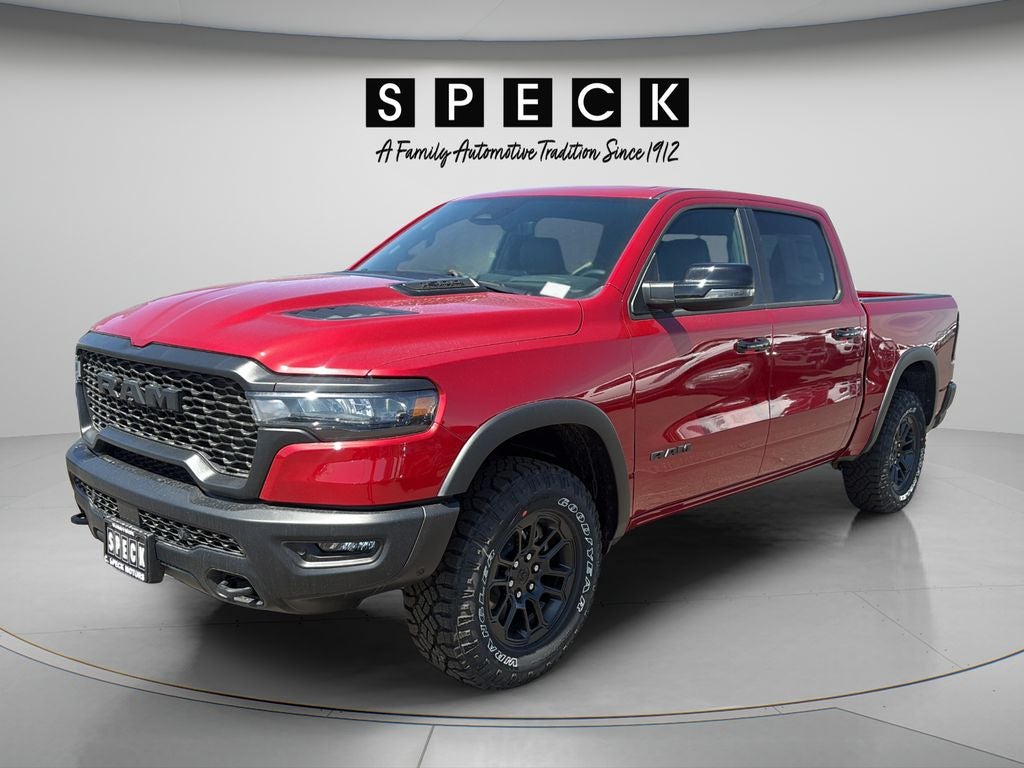 2026 RAM Ram 1500 RAM 1500 REBEL CREW CAB 4X4 5'7' BOX in Molten Red Pearl-Coat Exterior Paint — front three-quarter view